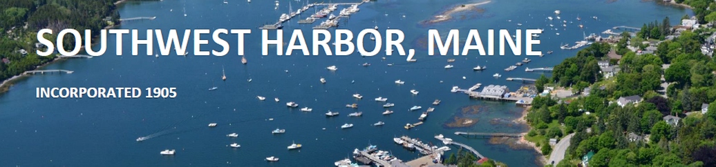 Aerial view of Southwest Harbor, Maine, incorporated 1905, showing the harbor, moored boats and village shoreline